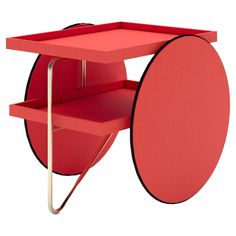 a red cart with wheels and shelves on it