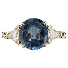 Natural Blue Oval Sapphire Diamond Three-Stone Gold engagement ring. GIA certified oval natural no heat sapphire center stone with 2 trilliant cut side diamonds in a 14k yellow setting. 1 oval soft medium blue Sapphire, approx. total weight 2.20cts, no heat, 9.52 x 8.05 x 3.89mm, GIA certificate #2171612821 2 trilliant cut diamonds, approx. total weight .38cts, I, SI Size: 5.5 and sizable 14k yellow gold Tested and stamped: 14k 4.4 grams Width at top: 9.52mm Height at top: 7.63mm Width at Bottom Kashmir Sapphire, Sapphire And Diamond Engagement Ring, Emerald Ring Engagement Diamond, Three Stone Diamond Ring, Platinum Diamond Engagement Rings, Handmade Engagement Rings, Ring Sapphire, White Gold Set, Three Stone Diamond