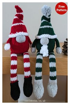 two knitted christmas dolls sitting next to each other