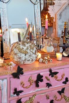 an ornate dresser with candles and decorations on it