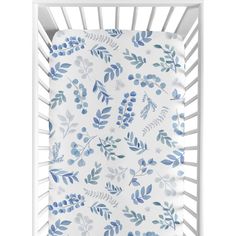 a white crib with blue leaves on it