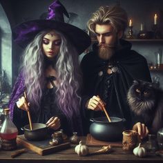 two people dressed as witches preparing food in a kitchen with cats and caulders