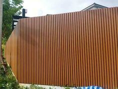 a large wooden fence next to a tall building