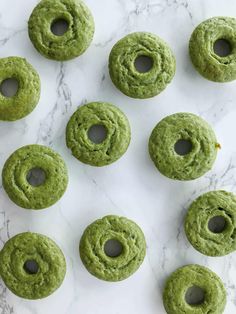 green doughnuts with holes in the middle on a marble surface