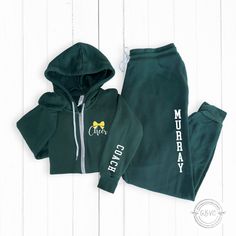 Show your appreciation with this custom zip-up hoodie and jogger set designed as the perfect cheer coach gift. Personalize it with their name and customize design colors for a thoughtful thank you gift. Available in unisex sizes XS to 2XL. ♥PIECES SOLD SEPARATELY OR AS 1 ZIP UP+JOGGER SET * IF YOU WISH TO MAKE ANY CHANGES TO THE ZIP UP DESIGN OR ADD ON TO SLEEVE OR BACK, PLEASE ADD DESIGN UPGRADE AVAILABLE HERE: https://rb.gy/dk7ni  TO SEE MY STOREFRONT FOR MORE ITEMS, GO HERE 👉🏼 https://www.e Sporty Fleece Tracksuit With Letter Print, Cotton Athleisure For Cheerleading, Sporty Letter Print Hoodie For Cheerleading, Sporty Cheerleading Hoodie With Letter Print, Cheer Hoodies, Custom Zip Up Hoodie, Cheer Coach Gifts, Cheer Coach, Add Design