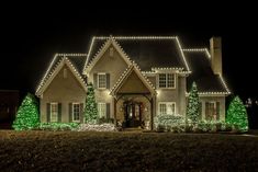 a house covered in christmas lights at night