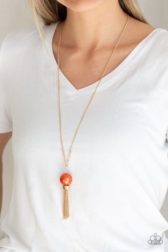 A dramatic pearly orange bead swings from the bottom of an elegantly elongated gold chain. Featuring a hammered fitting, a gold tassel streams from the bottom of the colorful pendant for a refined finish. Features an adjustable clasp closure.

Sold as one individual necklace. Includes one pair of matching earrings. Orange Necklace, Purple Necklace, All Gems, Gold Pearl Necklace, Paparazzi Accessories, Paparazzi Jewelry, Orange Gold, White Beads, Necklace Earring Set