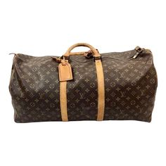 Timeless early 20th century Louis Vuitton Keepall travel Bag in classic monogrammed leather. Gold brass hardware, padlock and leather trim/tag all have the unique Louis Vuitton monogram. No key available.  Has double leather handles, 4.75" drop. Lightweight overnight or weekender bag. Rectangular Monogram Canvas Bag With Lock, Vintage Monogram Canvas Travel Bag, Monogram Canvas Travel Bag, Luxury Bag In Monogram Canvas With Brass Hardware, Rectangular Monogram Canvas Travel Bag, Monogram Canvas Travel Bag With Leather Trim, Travel Bag With Leather Handles And Monogram Canvas, Monogram Canvas Travel Bag With Leather Handles, Classic Monogram Canvas Travel Bag For Everyday Use