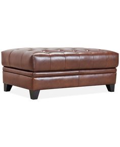 a brown leather ottoman with wooden legs