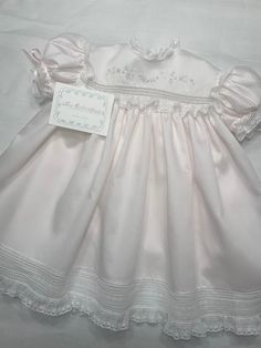 "Please Contact Before Ordering to Avoid Scheduling Conflicts. Toddler High-Yoke Gown Offered in Sizes 12-24 months Yoke Detail The front yoke features hand-embroidery just above a single row of French Lace Insertion. The back yoke also has the single row of Lace Insertion; the Centerback Button Band closes with MOP Buttons.  The Neckline is finished with Swiss Entredeux and gathered Lace Edging. The Yoke is 'framed' with gathered Lace Edging.  Sleeve Detail The short, puff sleeves are set into Baby Christening Dress, Aesthetic Outfits Y2k, Blessing Gown, Baby Heirloom, Heirloom Dresses, Baby Doll Pattern, Baby Dress Patterns, Frocks For Girls, Beautiful Girls Dresses