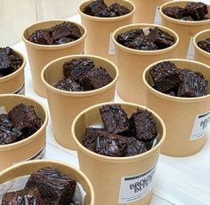 chocolate brownies in paper cups sitting on a table