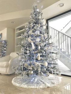 a blue and white christmas tree in a living room