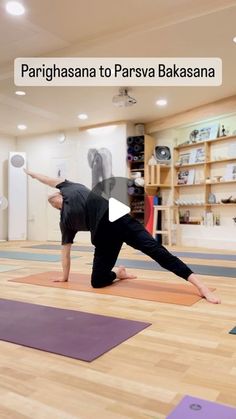 a woman is doing yoga on the floor in a room with wooden floors and shelves