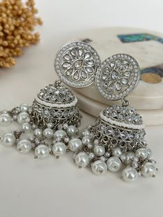 Silver Reverse american diamond jhumka. High quality polki work.  length- 2.5 inches  Style tip- Pair it with any beautiful traditional outfits  and flaunt with Unique style of collection from us. Perfect match for Festival and Traditional wear.  Take Care Tips-  Kee away from perfume, Hair spray and. Moisture.  Store in dry place , Ziplock bag or Airtight box.    Clean with dry cloth.  Jewellery is the last thing you should wear and first thing you should remove.  ------------------------------------------------ For customers outside Canada-  Some Countries apply import Duties and Taxes on goods which will be paid by customers . Please check your local regulations for more information. Cloth Jewellery, Peach Mirror, Trendy Silver Jewelry, Mirror Earrings, Vintage Inspired Earrings, Huggie Earrings Silver, Pretty Jewelry Necklaces, Fancy Jewellery Designs, Silver Statement Earrings