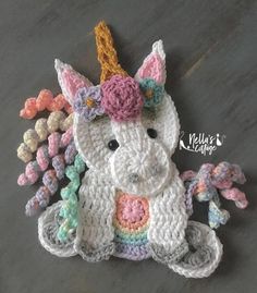 a crocheted stuffed animal with a unicorn horn on it's head and tail