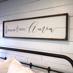 a bed with a wooden sign on the wall above it that says forever and given