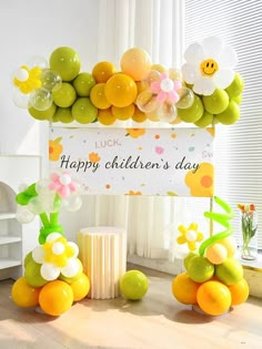 an arrangement of fruit and balloons for a happy children's day