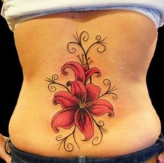 a woman's stomach with a flower tattoo on it