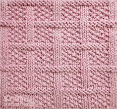 a pink knitted blanket is shown in close up, with small squares on it