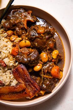 a bowl filled with rice, meat and beans