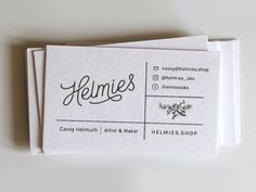 two business cards sitting on top of each other with the words, heimes