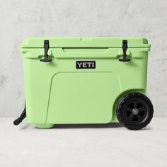 a green yeti cooler sitting on top of a white table next to a wall