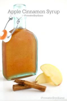 an apple cinnamon syrup is in a glass bottle