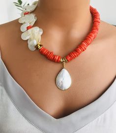 📍 Description :  This fashion unique handmade necklace is designed with orange  olour Coral gemstone and Mother of pearl stone.  💎Pendant :  Mother of Pearl 💥 The colours of the stones may differ slightly in photo shoots caused by lighting and reflections. The necklace is Modern chunky statement gemstone beaded asymetrical necklace for women. The necklace does not stretch and well kept its shape. ✂ Materials : The natural stones used are; Coral gemstone and Mother of Pearl stone The chain and