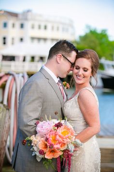 a bride and groom standing next to each other