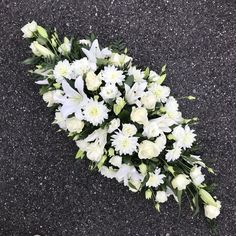 a bouquet of white flowers laying on the ground