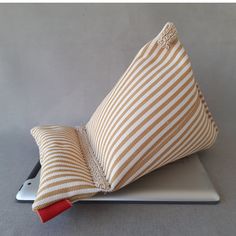 a pillow on top of a laptop computer