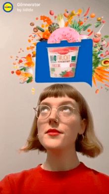 a woman with glasses is looking up at an ice cream advertisement