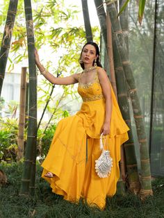 This beautiful yellow croma silk peplum Kurta is paired with croma silk sharara Pants. This outfit is completed with a georgette choker dupatta.