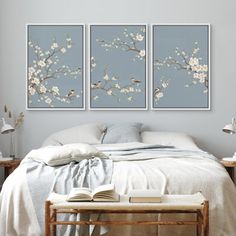 two paintings on the wall above a bed