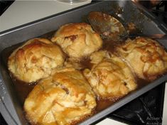 freshly baked pastries being cooked in an oven with a spatula on the side