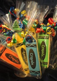 several crayons wrapped in cellophane and tied with ribbon on black background