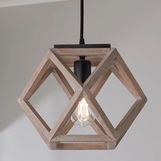 a wooden light fixture hanging from a ceiling