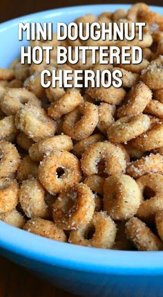 mini doughnuts in a blue bowl with the words, mini doughnut hot buttered cheerios