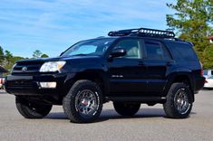 a black suv parked in a parking lot