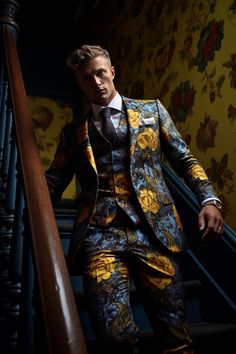 a man in a suit and tie sitting on the stairs next to a stair case