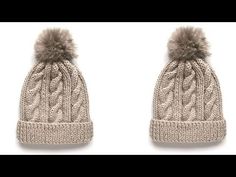 two hats with pom poms on top of each other, one is light brown