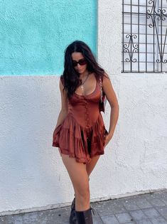 The most darling bustier romper dress. Slightly off-the-shoulder straps, with a slimming waist and a button-down closure along the front. The bottom fits like a romper, with a flattering & flowy mini-length skirt. Romper That Looks Like A Dress, Going Out Romper Outfit, Vanessa Mooney Romper, Barefoot Outfits, Aesthetic Romper, Country Concert Dress, Craft Clothes, Coachella Fits, Chocolate Satin