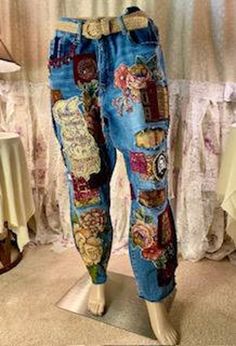 a mannequin is dressed up in jeans with patches and flowers on them,