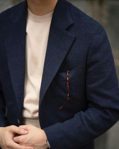 a man wearing a blue jacket and white shirt