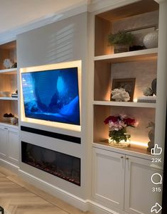 a living room with built in shelves and a television on the wall