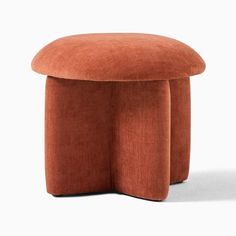 an orange stool sitting on top of a white floor