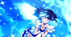 an anime character sitting on top of a blue box with stars in the sky behind her