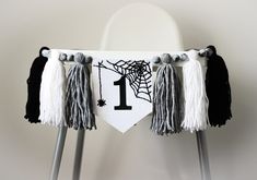 a chair decorated with tassels and a number one banner hanging from it's legs