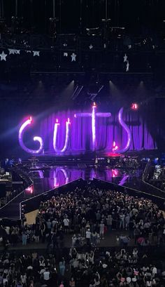 a large group of people standing in front of a stage with lights on it that says cutts day