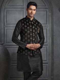 A velvet Nehru jacket paired with a black silk kurta pajama exudes a refined, regal look. The Nehru jacket, tailored in luxurious velvet, features a sleek, high-collar silhouette with a row of elegant buttons down the front. Its deep black hue adds a sophisticated touch, while the soft texture of the velvet enhances the jacket's opulence. Underneath, the silk kurta in matching black flows gracefully, offering a subtle sheen that complements the rich velvet. The kurta is simple yet elegant, paired with pajama pants in the same silky material, creating a monochromatic, seamless ensemble perfect for formal occasions. Indian vest, vest with kurta, Eid dress,kurta pyjama,diwali kurta pyjama,wedding kurta COST INCLUDES JACKET WITH KURTA PYJAMA Luxury Nehru Jacket With Naqshi For Reception, Luxury Self Design Nehru Jacket For Men, Black Nehru Jacket With Zari Work For Festivals, Black Nehru Jacket With Zari For Festivals, Black Nehru Jacket With Zari Work For Designer Wear, Traditional Black Nehru Jacket For Festive Season, Black Nehru Jacket For Festivals, Black Long Sleeve Nehru Jacket For Diwali, Festive Black Nehru Jacket